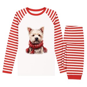 May include: White pajama set with a red and white striped long-sleeved top and matching pants. The top features a graphic of a white dog wearing a red scarf with pom-poms. The sleeves are red and white striped.