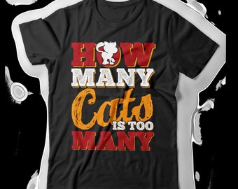 May include: Black t-shirt with a red, white, and orange graphic that says "How Many Cats Is Too Many".