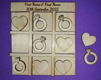 May include: A wooden tic-tac-toe game with the text "First Name & First Name 30th September 2025" at the top. The game pieces are hearts and rings with diamonds.