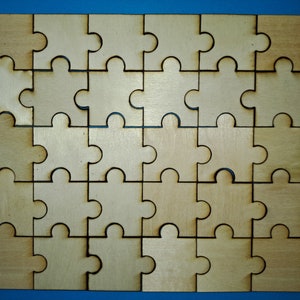May include: A wooden jigsaw puzzle with 25 pieces, all in the shape of a puzzle piece. The pieces are arranged in a 5x5 grid, and the puzzle is complete. The puzzle is made of light brown wood and has a natural finish.
