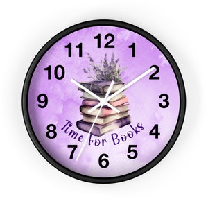May include: A purple and white clock with a black frame. The clock face features a stack of books with a bouquet of lavender on top. The text "Time For Books" is written on the clock face.