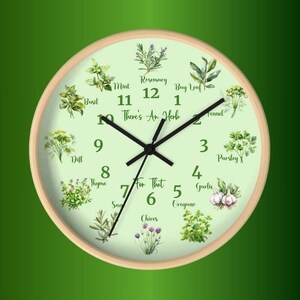 May include: A green and white round wall clock with a wood frame. The clock face features illustrations of herbs and spices with their names, and the text "There's An Herb For That".