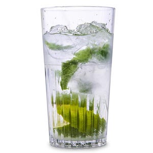 May include: A clear glass with a ribbed design filled with ice, water, a lime wedge, and a sprig of mint.