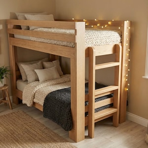 May include: A light-colored wooden bunk bed with a ladder, featuring two beds with beige bedding and a dark gray blanket. The room is decorated with framed botanical prints and a small potted plant.