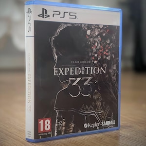 May include: A PlayStation 5 game case with a dark cover featuring the title "Clair Obscur Expedition 33." The case has a blue border and the PS5 logo. The cover art includes a silhouette and floral elements.