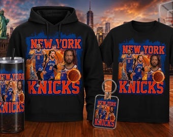 May include: A black hoodie, t-shirt, tumbler, and keychain featuring a New York Knicks design. The design includes team players, basketballs, and the words "New York Knicks" in orange and blue. The background shows a cityscape.