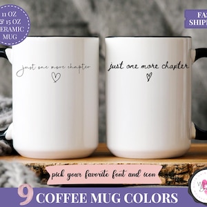 May include: Two white ceramic mugs with black handles and rims. Each mug has the text "just one more chapter" and a heart symbol. The mugs are displayed on a wooden surface. The image also includes text indicating the mug sizes and color options.