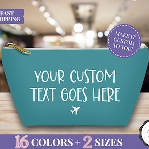 May include: Teal-colored zippered pouch with the text "YOUR CUSTOM TEXT GOES HERE" in white. The pouch has a gold zipper and a small airplane graphic. Additional text includes "MAKE IT CUSTOM TO YOU!" and "16 COLORS + 2 SIZES".