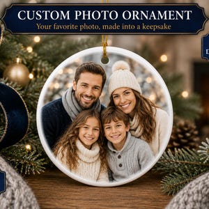 May include: A round white ceramic ornament featuring a printed photograph of a family of four. The text reads CUSTOM PHOTO ORNAMENT, Your favorite photo, made into a keepsake, SINGLE OR DOUBLE-SIDED, and 4 SHAPES AVAILABLE. The ornament has a gold hanging loop.