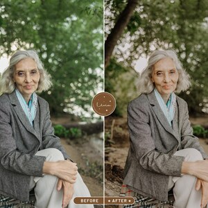 May include: A woman with gray hair is sitting outdoors wearing a gray blazer with a light blue scarf. She is sitting on a patterned blanket in front of a green leafy background.