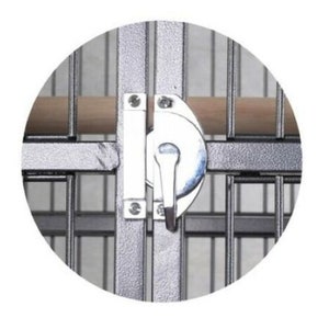 May include: A silver metal bird cage door latch featuring a rotating handle mechanism mounted on a gray wire frame. The latch is secured with visible screws and positioned horizontally across the cage bars, with a light brown wooden perch visible.