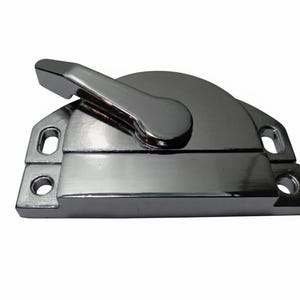 May include: A polished chrome window sash lock featuring a rectangular base with two mounting holes on each side and a rotating lever arm that secures the mechanism. The metallic finish is reflective and smooth, showing a clean, industrial design.