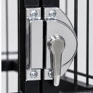 May include: A black metal wire cage door featuring a polished chrome latch mechanism. The latch consists of a rectangular strike plate and a semi-circular handle assembly, both secured with visible silver screws to the vertical frame bars.