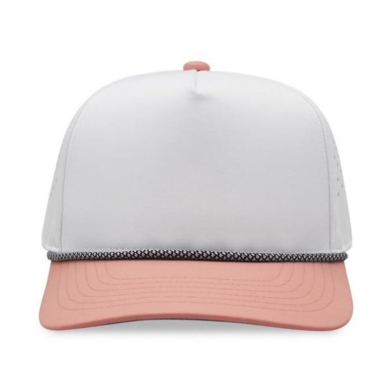 May include: A white trucker hat with a pink brim and a black and white rope detail. The hat has a mesh back and a pink button on top. This hat is a stylish accessory for outdoor activities.