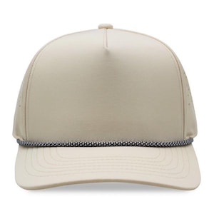 May include: A beige baseball cap with a curved brim and a black and white rope detail. The cap has a structured crown with small ventilation holes on the sides. The hat is a neutral color.