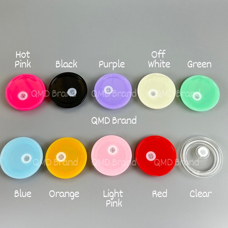 May include: Assortment of 10 round plastic lids in various colours, including hot pink, black, purple, off white, green, blue, orange, light pink, red, and clear. The lids have a small hole in the centre.