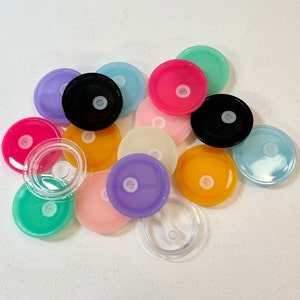 May include: Assortment of colourful plastic lids in various shapes and sizes. The lids are perfect for crafts, DIY projects, and more.