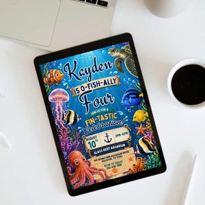 May include: A digital invitation on a tablet screen featuring an underwater theme with a sea turtle, clownfish, jellyfish, octopus, and blue tang. Text reads: Kayden is O-Fish-Ally Four, Join us for a Fin-Tastic Celebration, August 10th, 2pm-4pm, Glass Reef Aquarium, 500 Downtown Aquarium Drive, Houston, TX 77002, RSVP to Sarah 203-456-7890.