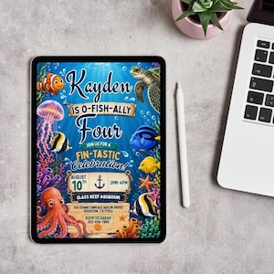 May include: A digital tablet displaying an underwater-themed birthday invitation for Kayden, who is turning four. The design features a clownfish, sea turtle, jellyfish, octopus, and various tropical fish against a blue background with text.