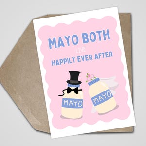 May include: A greeting card with a pink background and the words "MAYO BOTH LIVE HAPPILY EVER AFTER" in blue. Two cartoon mayonnaise bottles are depicted, one with a top hat and bow tie, the other with a veil.