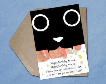 May include: A birthday greeting card featuring a black cat face with white eyes and a white nose. The card includes the text "Happy birthday to you" and a request for a treat. The card is inside a brown envelope.