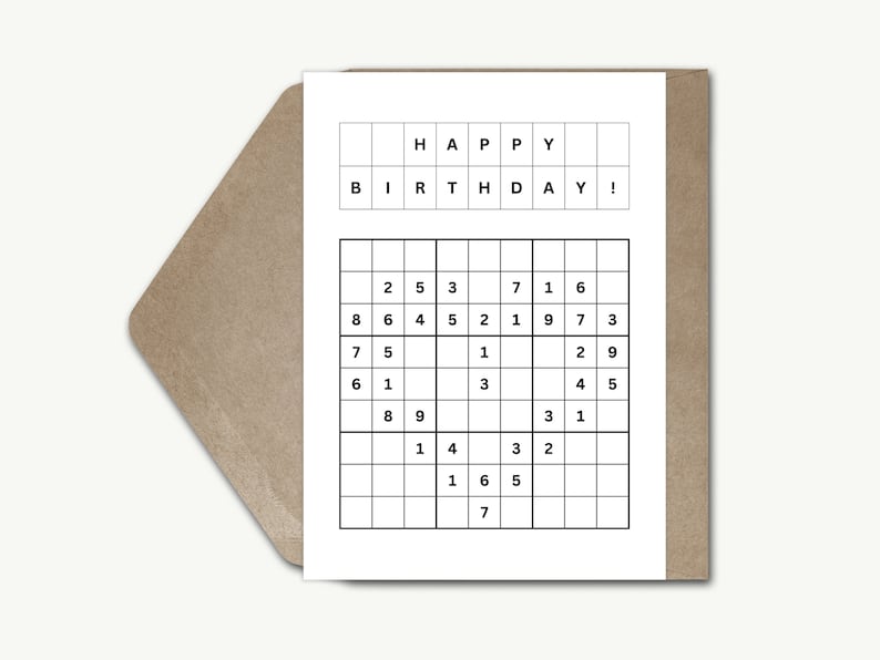 May include: A white card with the words "HAPPY BIRTHDAY!" printed in black. Below the greeting is a partially completed Sudoku puzzle.