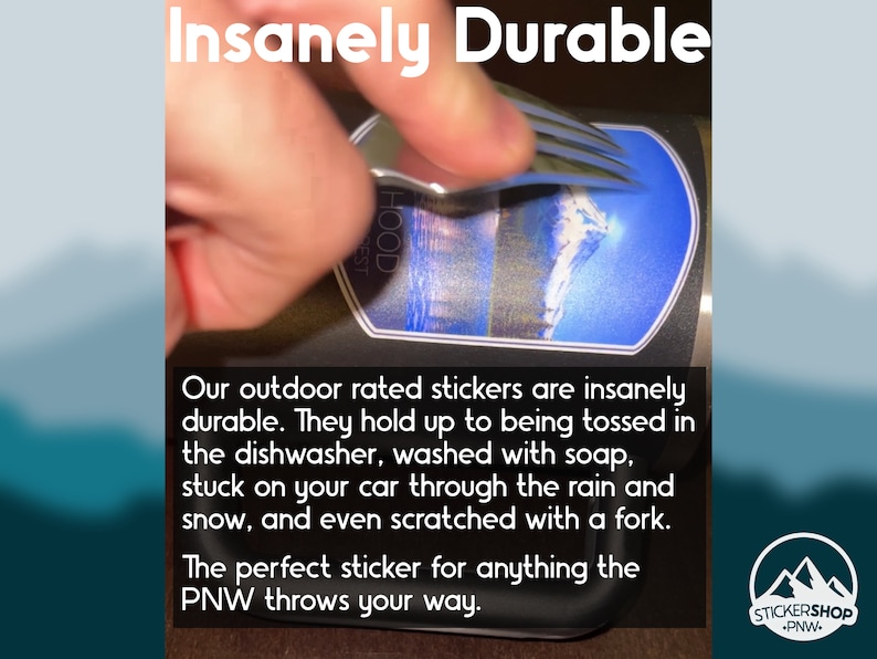 May include: A sticker featuring a mountain landscape graphic applied to a dark surface, with a metal fork scraping across the surface. The text reads Insanely Durable, Our outdoor rated stickers are insanely durable, and STICKERSHOP PNW.