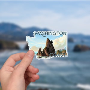 May include: A sticker featuring a stylized outline of the state of Washington with a scenic image of a rocky coastline and the text "WASHINGTON COAST".