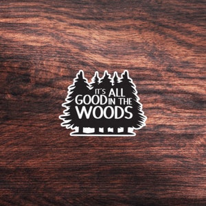 May include: Black and white sticker with a silhouette of five pine trees and the text "It's all good in the woods".