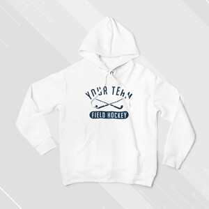 May include: White hooded sweatshirt with a navy blue graphic of crossed field hockey sticks and the text "YOUR TEAM FIELD HOCKEY".