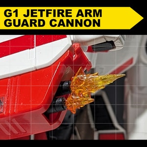 May include: Close-up of a red and white robot arm with a black and orange cannon. The cannon is firing a blast of orange energy.