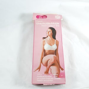 May include: A pink and white box with a white bra inside. The box has the text "Flexnit Give-A-Little-Middle Tricot Contour Bra" on it. The text "Unique 'Give-A-Little-Middle' moves as you move...gives you a great shape with complete freedom and comfort." is also on the box.