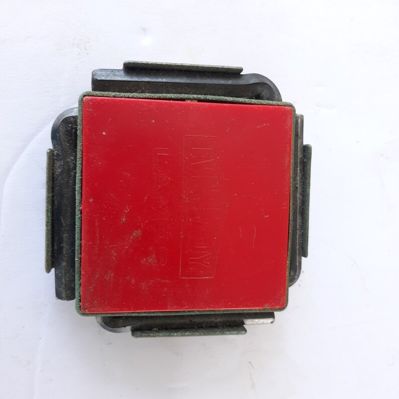 May include: A red square-shaped stamp with black lettering that reads "EASY" and "INK" on a black plastic frame.
