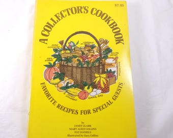 May include: A yellow cookbook titled "A Collector's Cookbook" with a basket illustration on the cover. The cover also includes the text "Favorite Recipes for Special Guests" and the price $7.95.