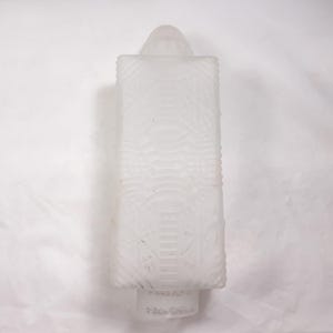 May include: White frosted glass candle holder with a geometric pattern. The holder has a rounded top and a square base.