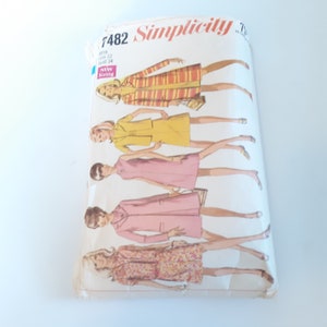 May include: Vintage Simplicity sewing pattern number 7482 for misses sizes 12-14 bust 34. The pattern features five different dress designs, including a striped dress, a yellow dress, a pink dress, a pink dress with a long sleeve jacket, and a floral print dress.