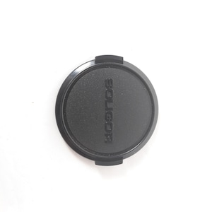 May include: Black lens cap with the word "SOLIGOR" embossed on the top.
