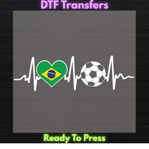 May include: A white graphic design featuring a soccer ball and a heart with the Brazilian flag inside, integrated into a heartbeat line. The text "DTF Transfers" is at the top, and "Ready To Press" is at the bottom.