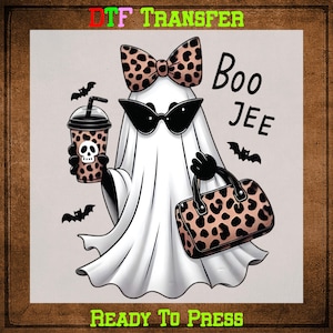 May include: A cartoon ghost wearing sunglasses and a bow tie with a leopard print design. The ghost is holding a leopard print purse and a drink with a skull design. The words "Boo Jee" are written in black.