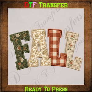 May include: A DTF transfer sheet featuring the word FALL in large block letters. The F is dark green with a floral pattern, the A is cream with a floral print, the L is orange and white gingham, and the second L is cream with a plaid floral design.