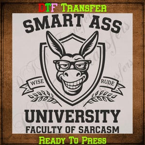 May include: A black and white graphic design featuring a smiling donkey wearing glasses, inside a shield. The text reads "SMART ASS UNIVERSITY FACULTY OF SARCASM" with "WISE" and "RUDE" on banners. The words "READY TO PRESS" are also visible.