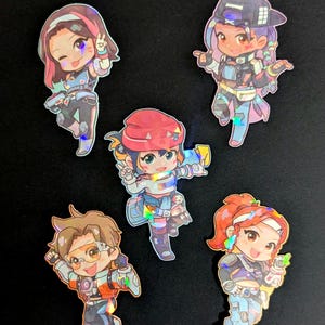 May include: Five holographic stickers featuring anime-style characters in various poses. The characters have colorful hair, outfits, and accessories. The stickers are on a black background.