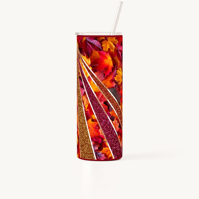 May include: A stainless steel tumbler with a red lid and a design of autumn leaves with gold and pink glitter accents.