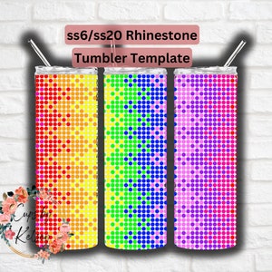 May include: Three stainless steel tumblers with a rainbow rhinestone design. The tumblers are white with a gradient of red, orange, yellow, green, blue, and purple rhinestones.