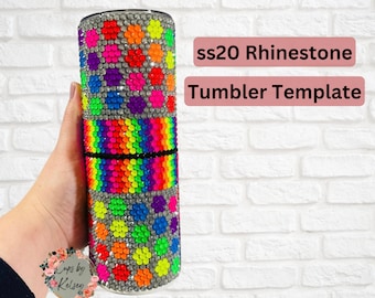 May include: A clear tumbler with a rainbow and multi-colored polka dot design made with rhinestones. The tumbler is being held by a hand. The text "ss20 Rhinestone Tumbler Template" is displayed above the tumbler.