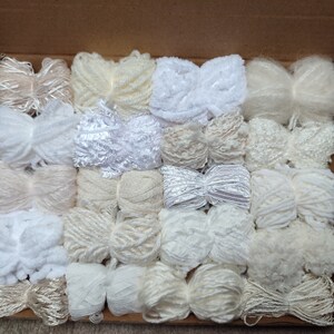 Example of a pack of 20 yarn bundles in creams, whites and neutrals with various weights, types and textures.