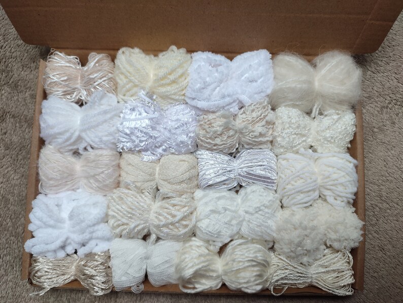Example of a pack of 20 yarn bundles in creams, whites and neutrals with various weights, types and textures.