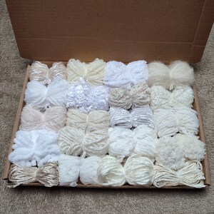 Mixed pack of 20 yarn bundles in creams, whites and neutrals with various weights, types and textures.
