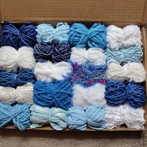 Pack of white and blue yarn bundles. Various weights, types and textures. For weaving and much more.