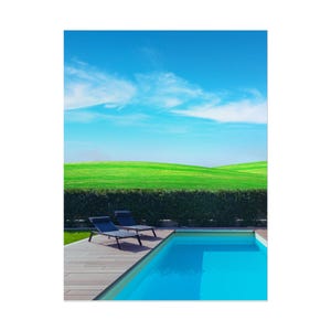 May include: A serene outdoor scene featuring a bright blue swimming pool with clear water, two black lounge chairs, and a wooden deck. The background showcases a vibrant green lawn, a hedge, and a clear blue sky with wispy clouds.